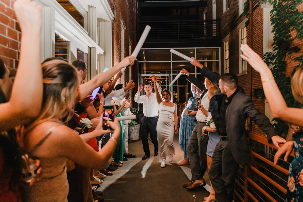 bride and groom walk through exit at wedding reception