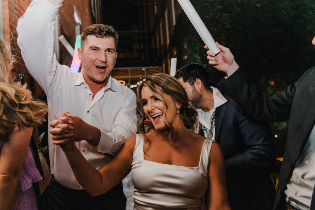 bride and groom walk through exit at wedding reception