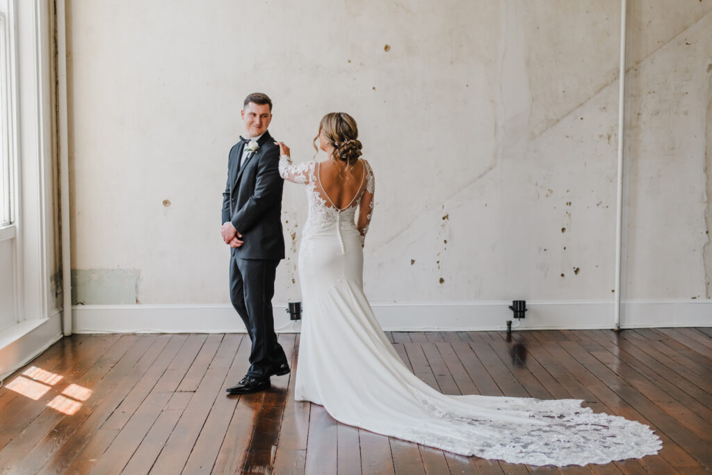 Bride and groom exchange first look on their wedding day at excelsior in lancaster pennsylvania