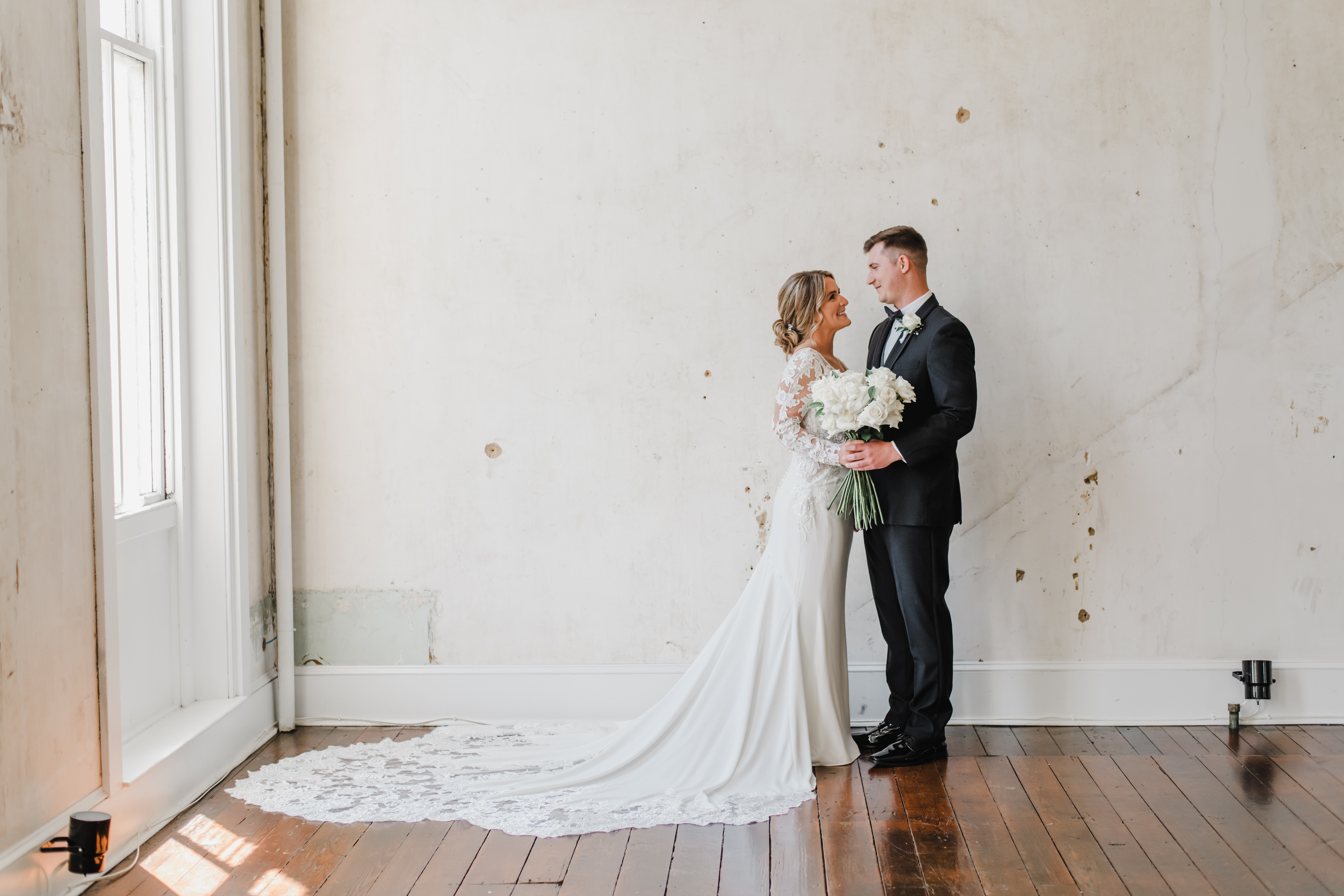 Bride and Groom stand to take portrait at Excelsior in Lancaster, Pennsylvania