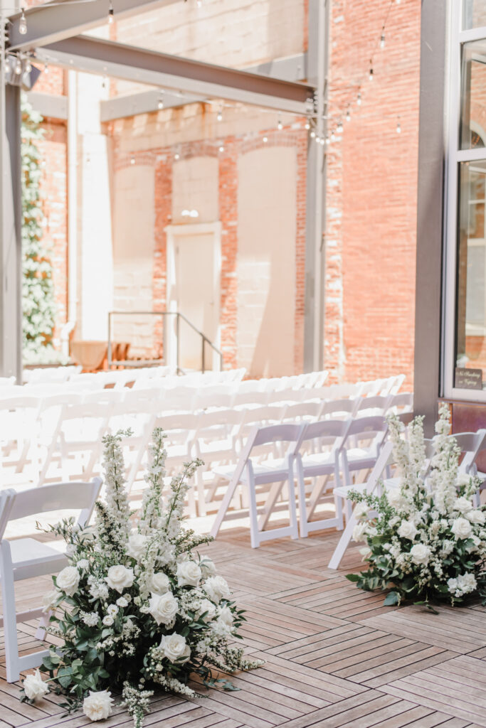 Excelsior wedding venue ceremony space decor with white and green florals