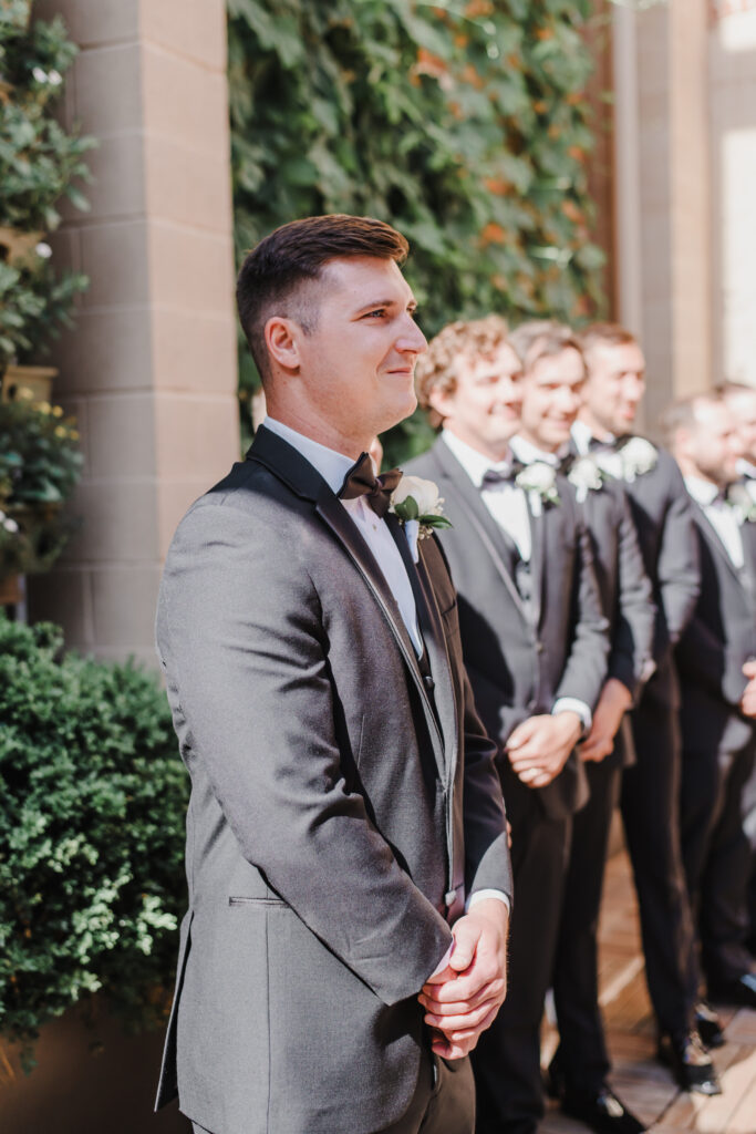 groom looks toward bride walking down the aisle at excelsior in lancaster pennsylvania