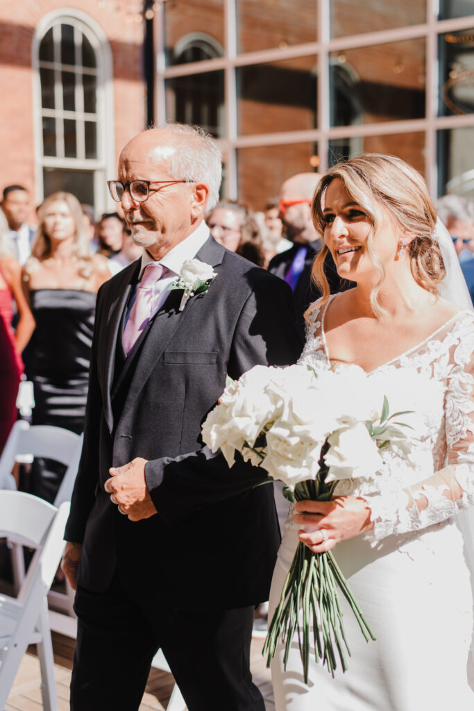 bride and her father walk down the aisle at excelsior in lancaster pennsylvania