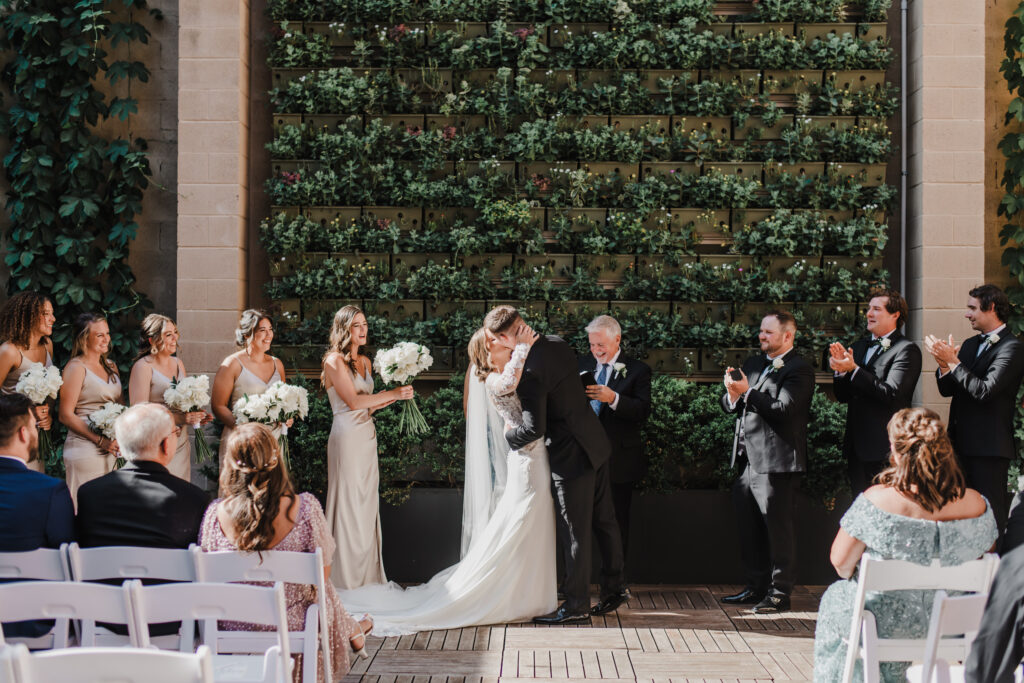 bride and groom exchange first kiss during ceremony