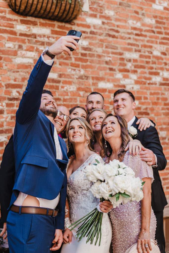 family takes photo after wedding ceremony