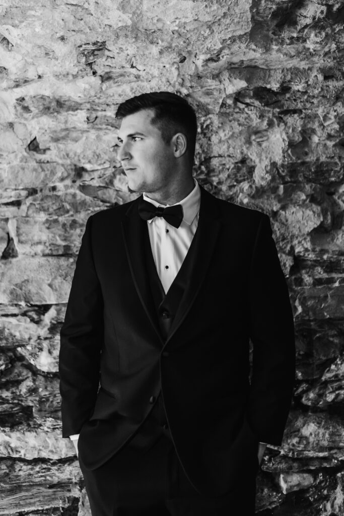 black and white photo of groom on wedding day at excelsior